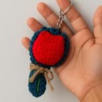 Keychain with red and blue crochet design, handmade accessory.
